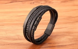 Macro shot of multilayer black braided leather bracelet with matte black magnetic buckle