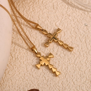 Minimalist 18K gold plated stainless steel cross pendant necklace on textured background