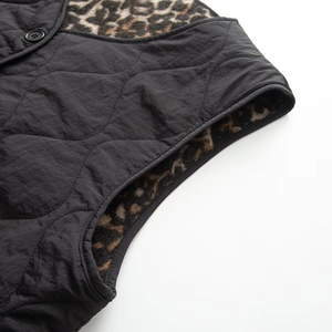 Detail of black quilted vest with leopard faux fur lining and snap button closure