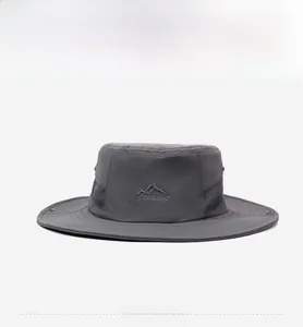 Detail of dark grey sun hat with breathable mesh side panels and mountain logo embroidery