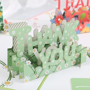 Close-up of 3D pop-up thank you card with green stripes and daisy floral design