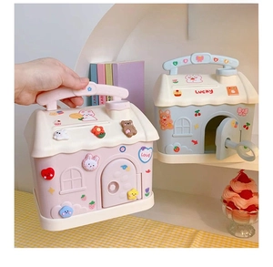 Close-up of cartoon house piggy bank with handle, lock key and cute 3D stickers