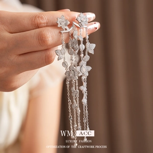 Elegant silver tassel earrings with flower petals and inlaid zircons on a soft brown base