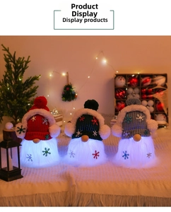 Close-up of glowing Christmas gnomes in red, green, and grey with snowflake knit hats