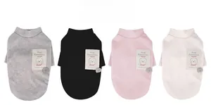 Detail of soft pet sweaters in grey, black, pink and white with stay pawsitive patch