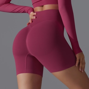 Detail of high-waist scrunch butt seamless yoga shorts in deep mulberry knit fabric