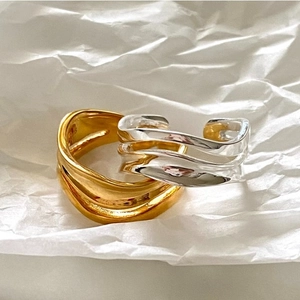 Minimalist 925 sterling silver wavy open rings in gold and silver finish on white paper