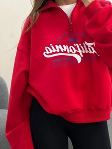 Close-up of red half-zip sweatshirt with California 1871 vintage print details