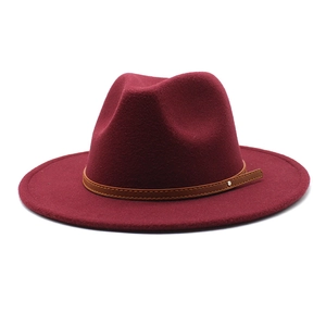 Close-up of burgundy wool fedora hat with brown leather belt and silver metal stud detail