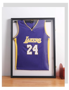 Detailed black jersey display frame with Lakers jersey mounted on a wooden table surface