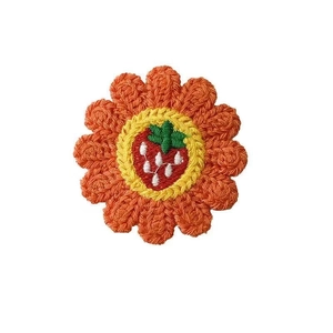 Handmade crochet sunflower hair clip with strawberry center and vibrant knit texture