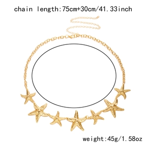Detailed view of golden starfish chain belt with textured sea star charms and adjustable clasp