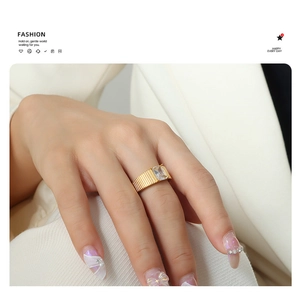 Detail of 18K gold plated ribbed band ring with a large rectangular zircon stone