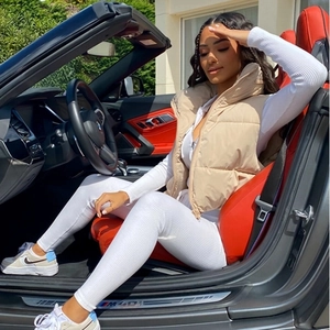 Detail einer beige gesteppten Weste und Strickwaren, getragen in einem Luxus-Cabriolet
