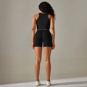 Rear view of seamless black ribbed workout set featuring racerback tank and bike shorts
