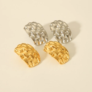 Macro shot of 18K gold and silver stainless steel C-shaped earrings with woven texture