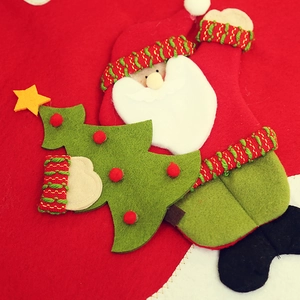 Close-up of 3D Santa and polka dot tree detail on Christmas tree skirt fabric