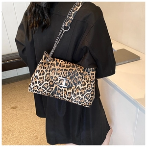 Fashionable leopard print shoulder bag with metal chain strap and T-buckle on model