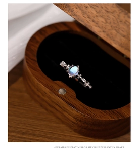 Macro shot of silver ring with blue moonstone in a luxury wooden jewelry gift box