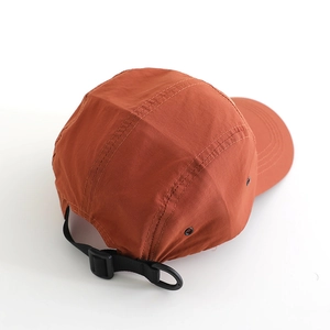Rust red breathable nylon camper hat featuring an adjustable back strap and buckle
