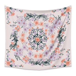 Detail of bohemian mandala tapestry featuring pink background with purple floral patterns
