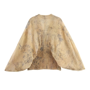 Floral puff sleeve top with deep V-neck and smocked waist in beige and blue print