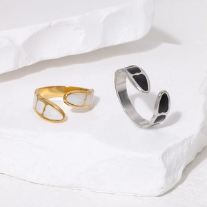 Detailed close-up of heart-shaped enamel rings on a textured white stone base