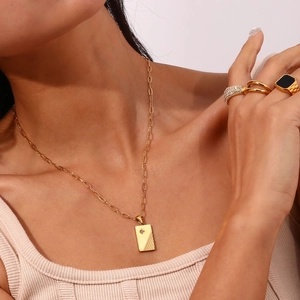 Detail shot of 18K gold plated striped zircon pendant necklace and matching fashion rings