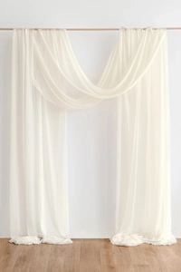Detail of elegant cream chiffon wedding arch drapes with smooth texture and graceful folds