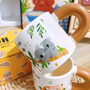 Stack of ceramic mugs featuring cute cartoon koala and fox animal zoo patterns