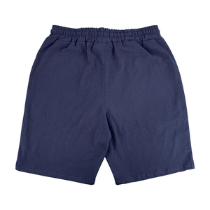 Detailed view of dark blue cotton linen shorts with elastic waist and fabric texture