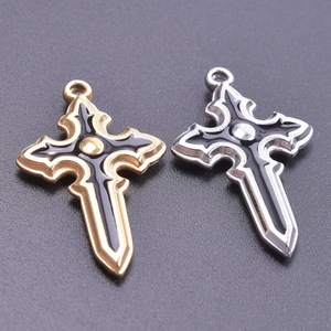 Detail of gold and silver gothic sword cross pendants with black enamel finish