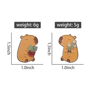 Detailed view of cartoon capybara enamel pins with flower and plant designs
