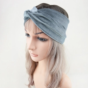 Close-up of a grey velvet twisted headband showing fabric texture and knotted style