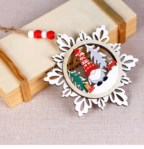 Close-up of wooden snowflake ornament with gnome and red truck holiday scene