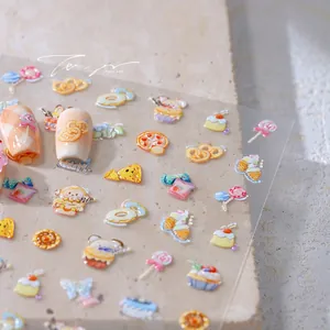 Macro detail of 3D embossed nail art stickers featuring cute cartoon dessert patterns