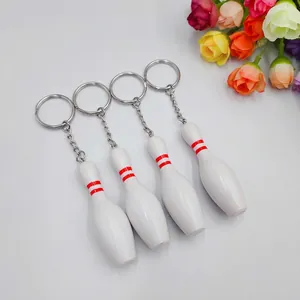 Miniature white bowling pin keychains with red stripes and silver metal rings set of 4