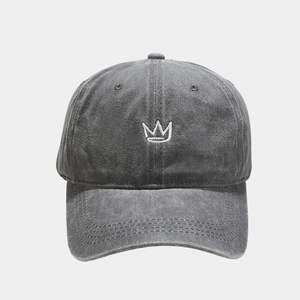 Detailed view of white crown embroidery on vintage charcoal grey washed cotton baseball cap
