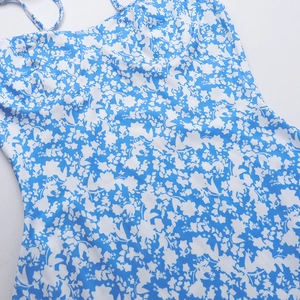 Detail showing elegant blue and white floral print and neckline texture of the dress