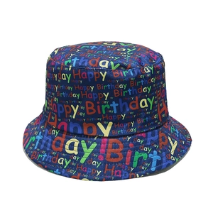 Detailed view of colorful Happy Birthday printed lettering on a navy blue bucket hat for parties