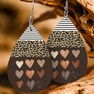 Teardrop earrings with leopard print and heart patterns on wood background