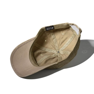 Detail view of khaki washed cotton baseball cap showing interior structure and adjustable strap