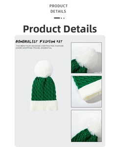 Detail view of thick green cable knit texture and white pompom on a kids winter hat