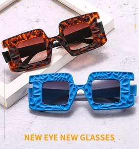 Detail view of square sunglasses with unique lava texture in amber and blue frames