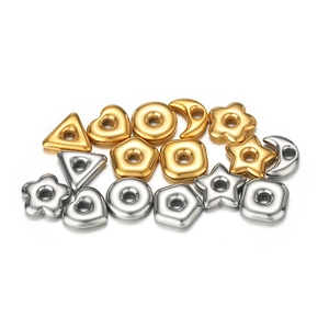 Macro detail of moon, star and geometric spacer beads in gold and silver for DIY jewelry