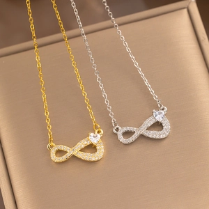Silver and gold infinity necklaces with sparkling cubic zirconia on a jewelry box