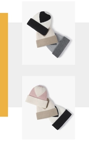 Detail of ribbed knit beanies with jacquard heart patterns in various seasonal colors