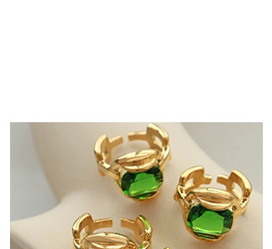 Close-up of vintage gold open rings with emerald cat's eye stone and hollow design