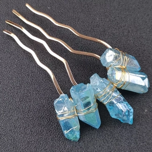 Macro detail of natural blue crystal stones hand-wrapped on a golden metal hair comb fork