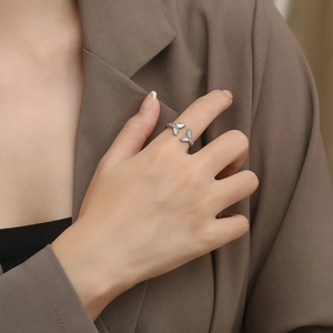 Elegant fishtail ring with white shell inlay worn by model in professional office setting